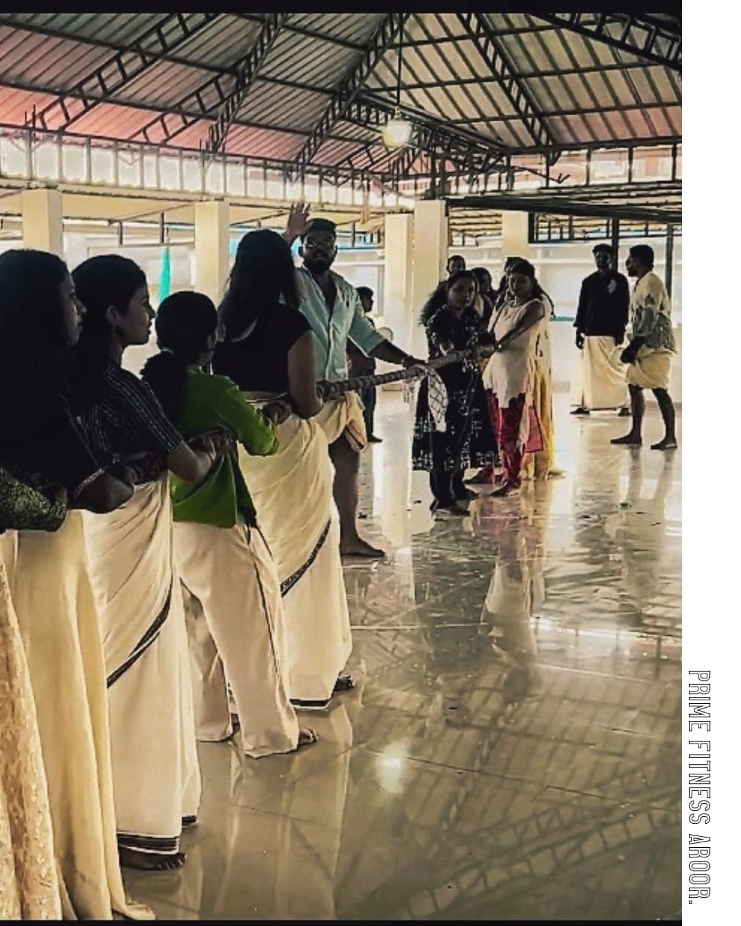 Members lined up for a group game at the Onam venue
